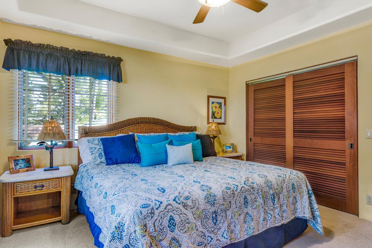 Bedroom with bed, nightstand, wooden closet, and window with blue accents.