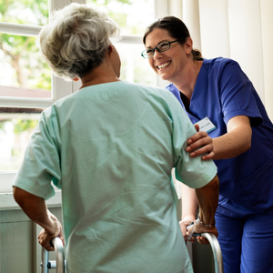 Nurse checking on elderly female patient