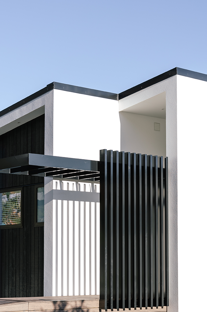 A white house with a black fence in front of it
