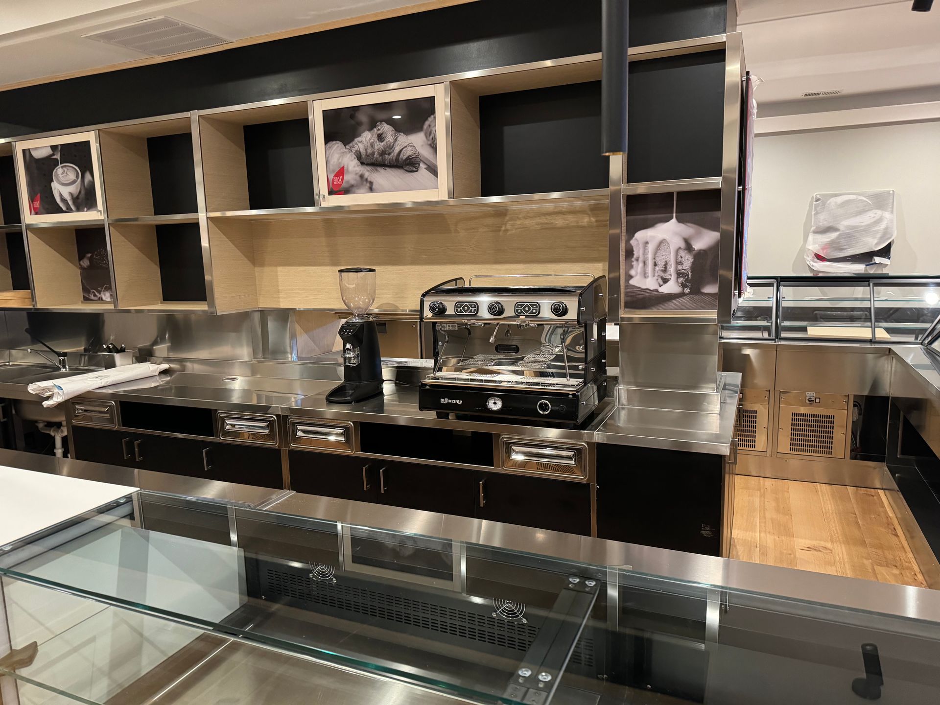 A kitchen with stainless steel appliances including a coffee machine