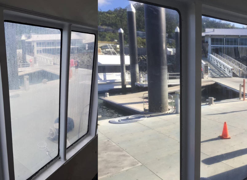 A person is cleaning a window with a high pressure washer — Pain in the Glass Window Cleaning in Cannonvale, QLD