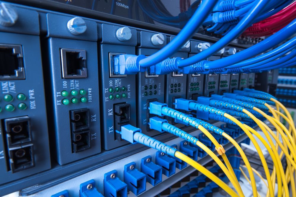 Blue Network Cables Connected to a Server Rack With Blinking Status Lights — Comms Cabling Central Coast In Kanwal, NSW