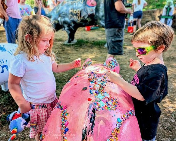 Two children playing at a colorful outdoor foam-covered event
