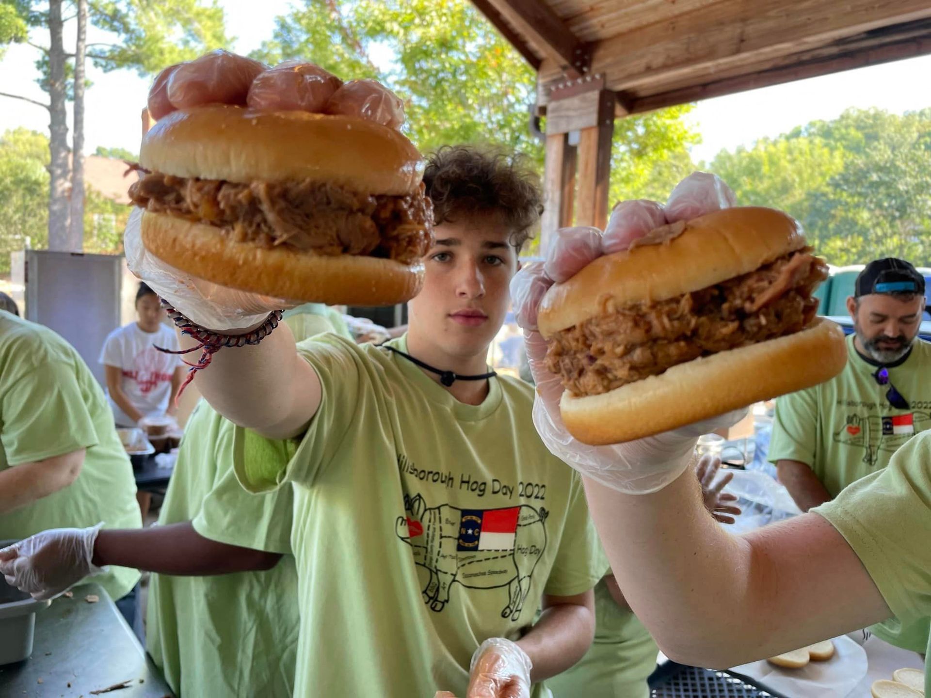 Volunteers showing off BBQ sandwiches