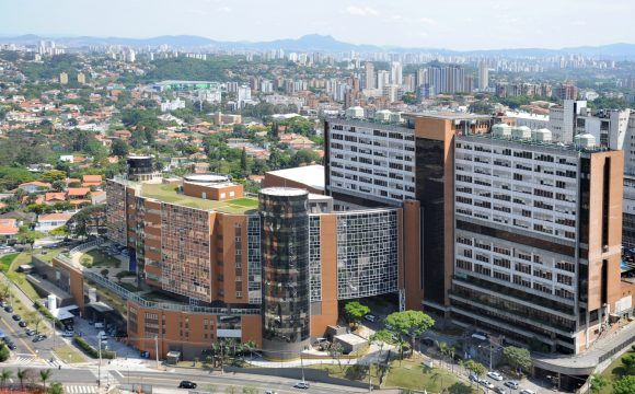 An aerial view of a large building in the middle of a city.