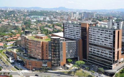 An aerial view of a large building in the middle of a city.