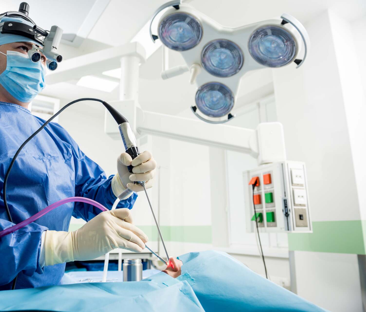 A surgeon is operating on a patient in an operating room