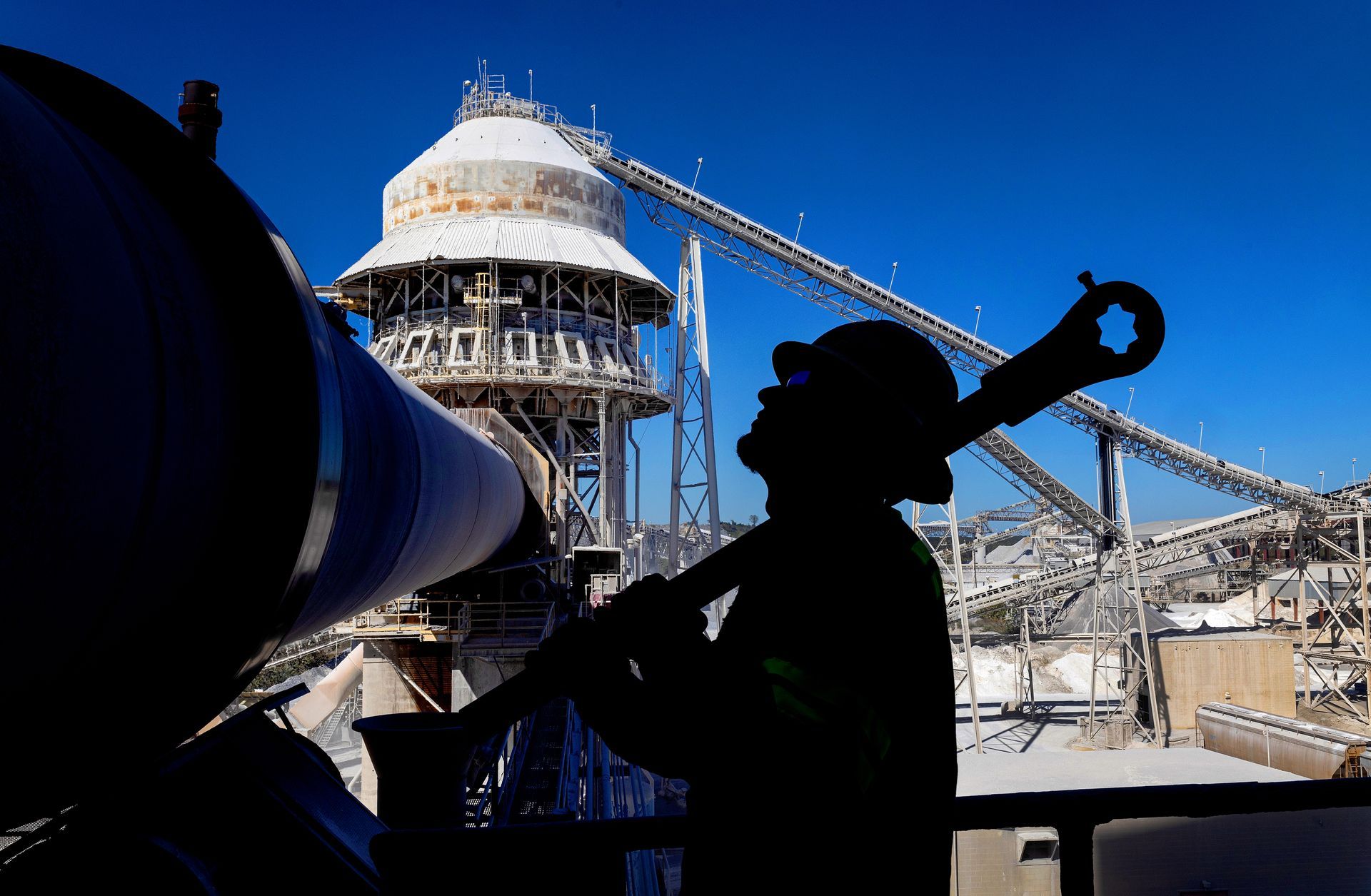 
Industrial maintenance engineer servicing heavy equipment in manufacturing plant environment.
