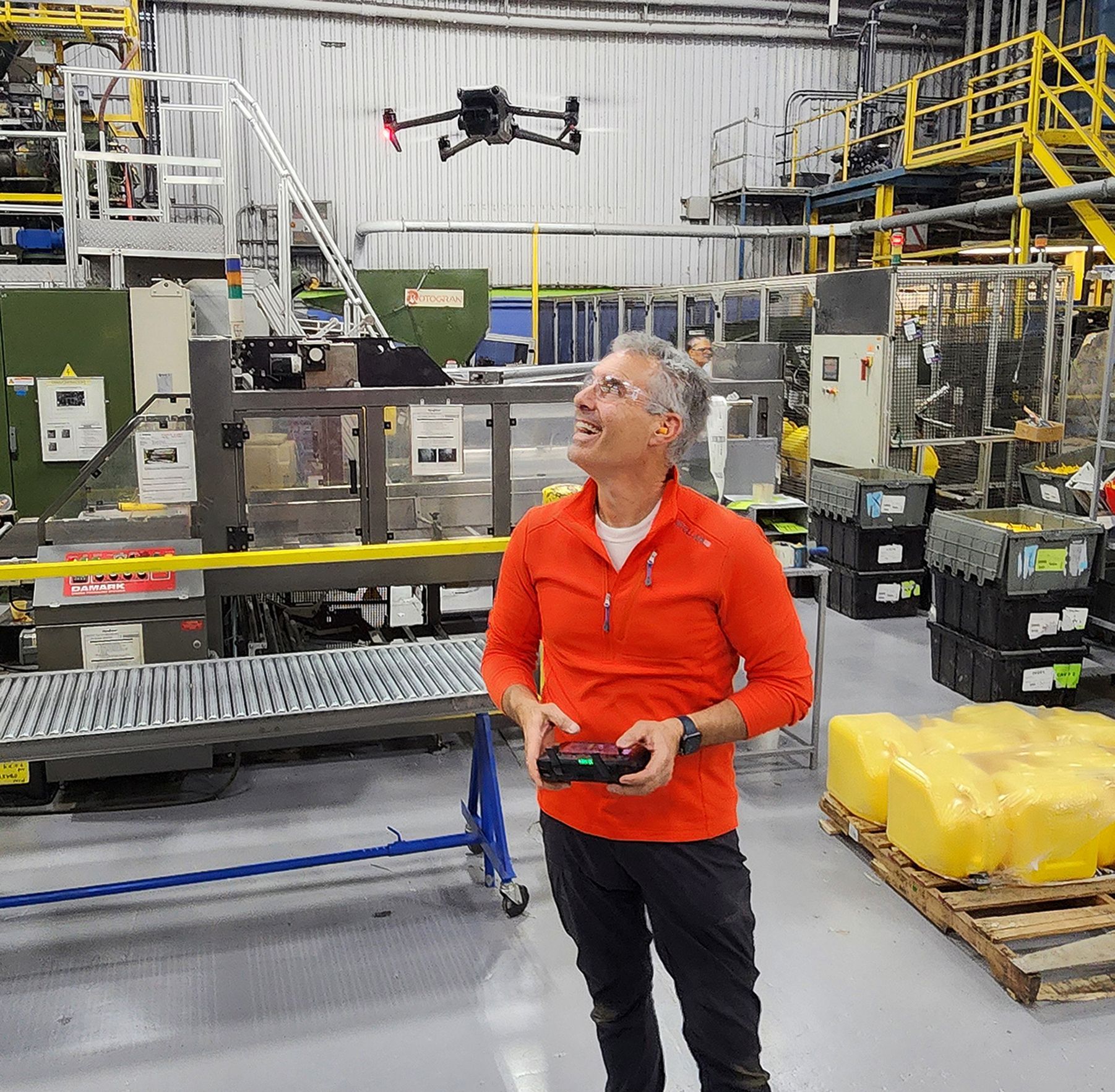 Inside the bustling production floor, FAA-certified drone pilot Patrick Schneider skillfully navigates his UAV through a maze of active machinery, capturing unique perspectives of the manufacturing process. His precision control allows him to document hard-to-reach areas while maintaining strict safety protocols and avoiding any disruption to ongoing operations.