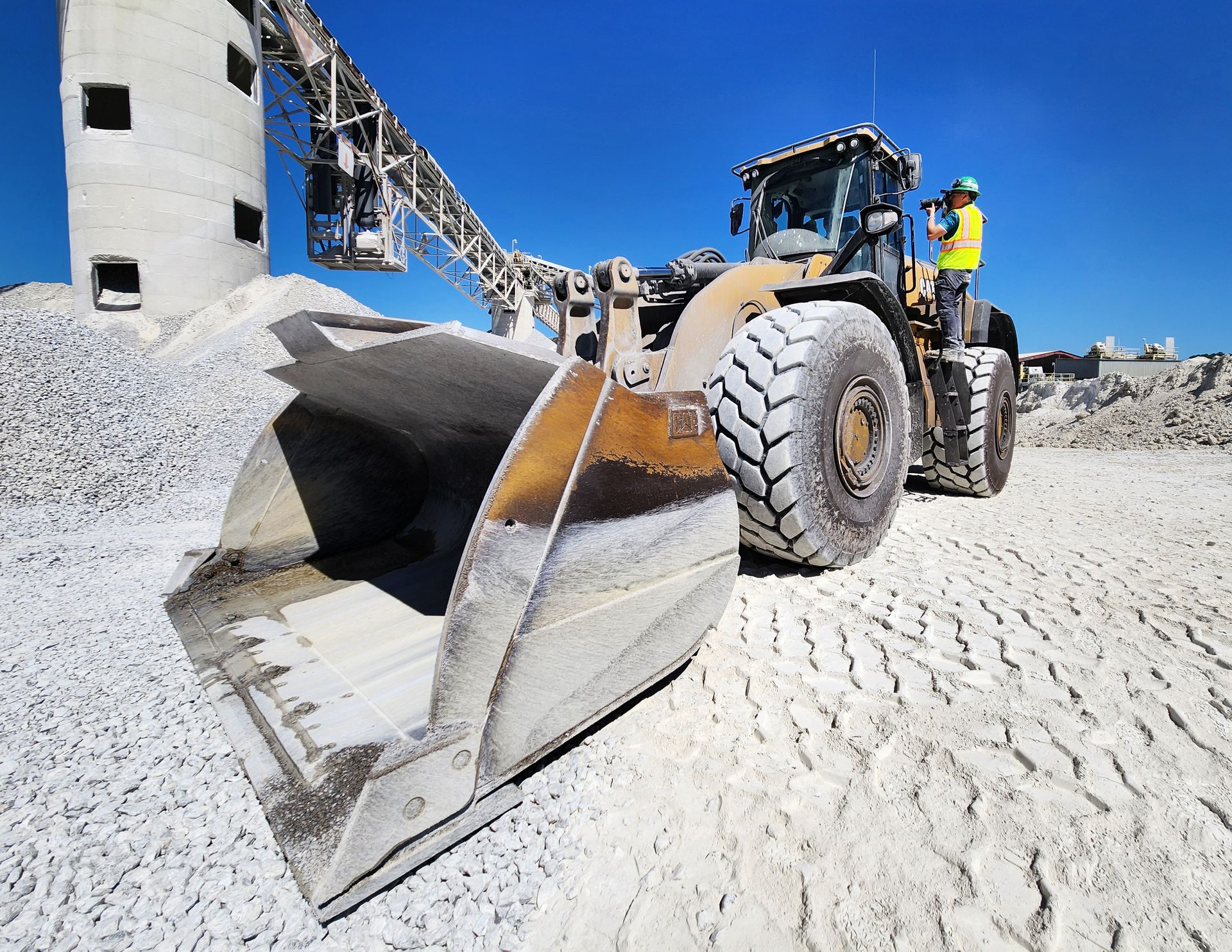 Your workers know their jobs inside and out - we match that dedication by getting as close as safety allows to capture their craftsmanship. Here industrial photographer Patrick Schneider stands on the edge of a giant earth moving machine to take photos of the worker on the other side of the driver's window.