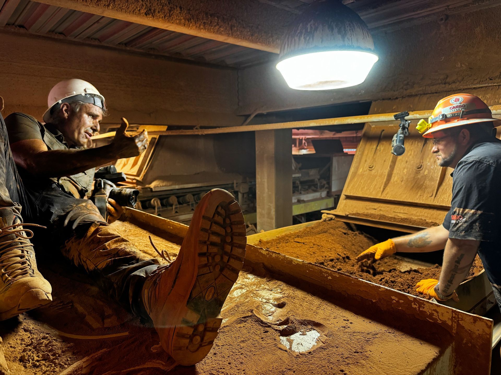 We climb, crawl, and maneuver into challenging positions to capture authentic industrial moments that showcase your team's expertise. Here photographer Patrick Schneider practically crawls inside the operations to get up close to the employee doing the work.