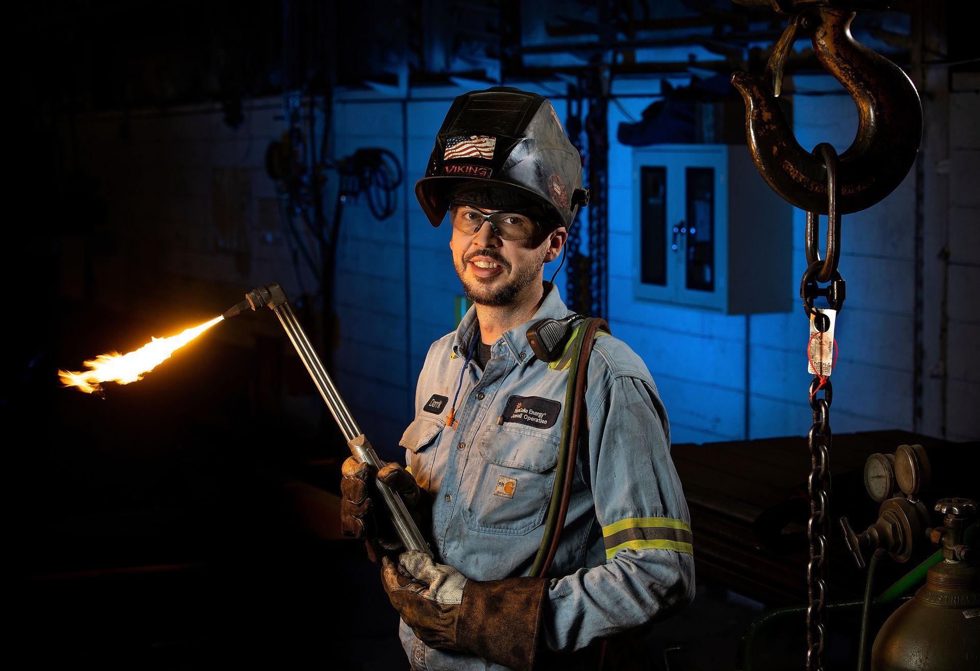 Manufacturing welder executing precision metal fabrication processes, demonstrating advanced industrial welding techniques in factory setting.
