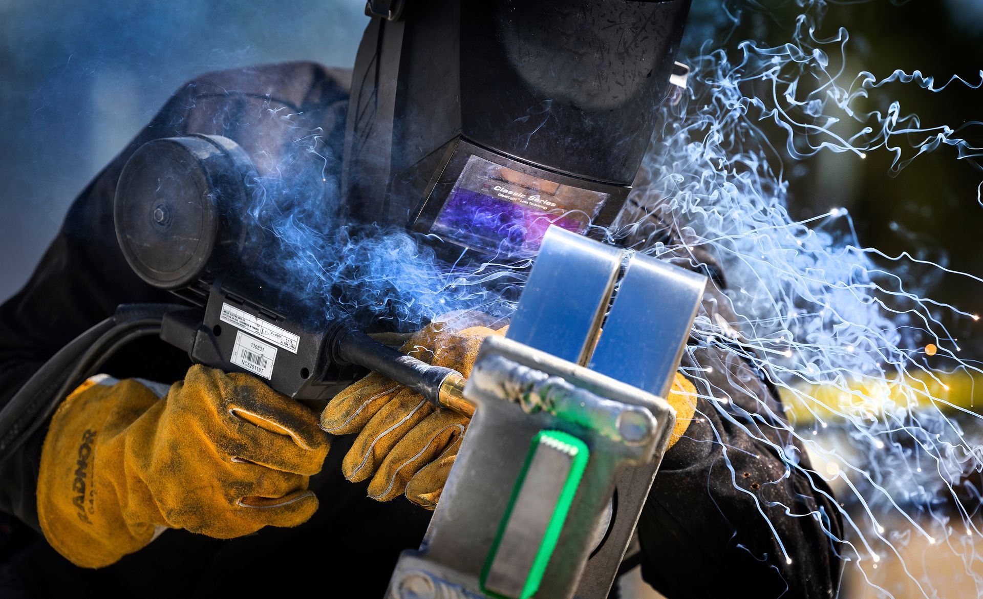 Industrial welding specialist performing critical manufacturing assembly, showcasing specialized metalworking expertise in production environment.