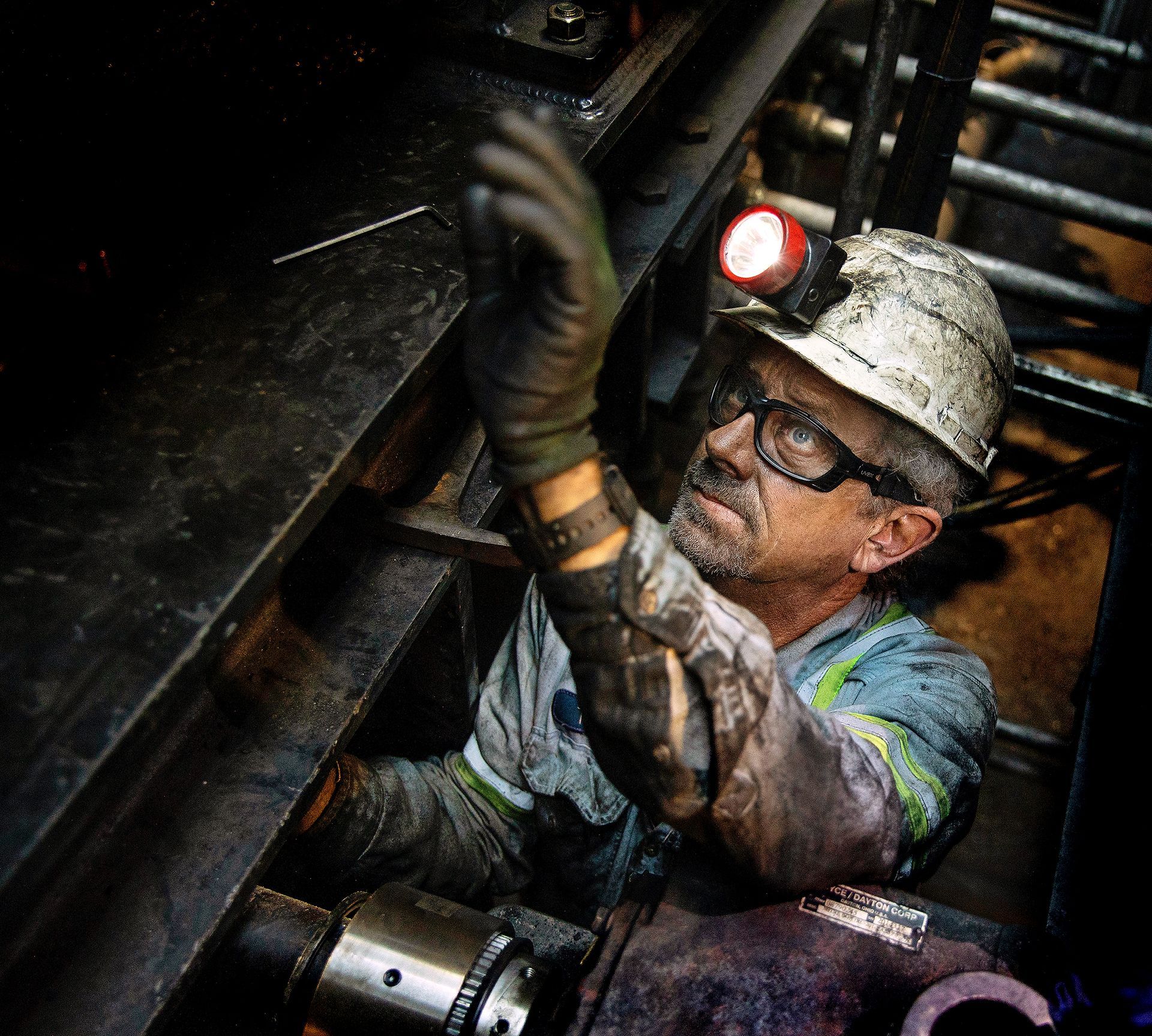 Industrial worker demonstrating precision manufacturing processes in production facility.