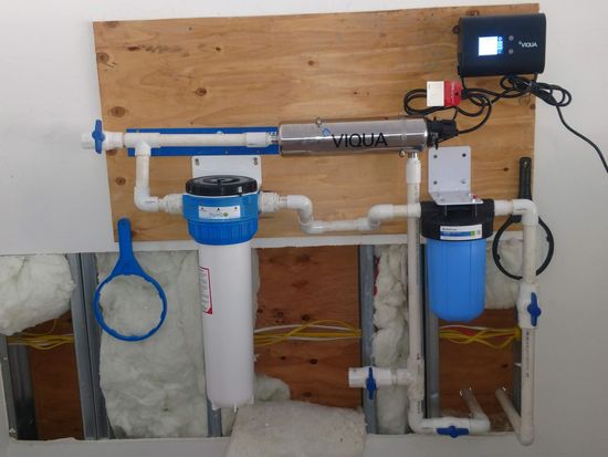Water Filtration System - Georgetown, CA | DMI Pump Service Inspector holding glass of water - Georgetown, CA | DMI Pump Service