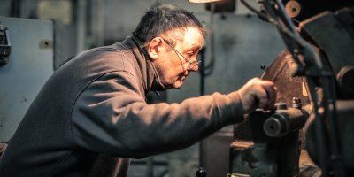 A man is working on a machine in a factory.