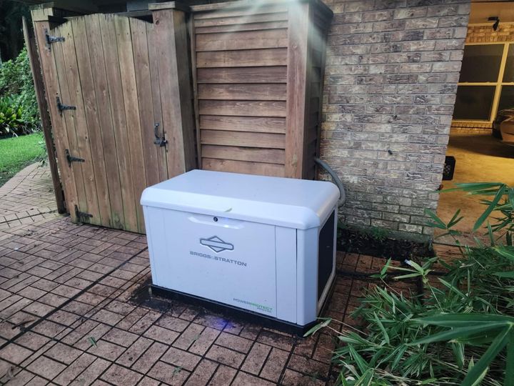 White outdoor storage box beside a wooden gate and brick wall in a garden patio area