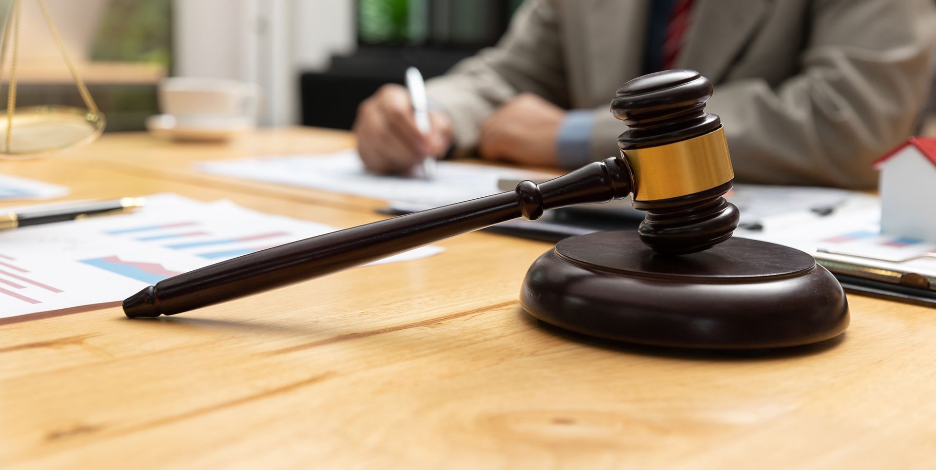 Judge's gavel rests on a desk with papers and a pen, representing the Law Offices of Richard J. McCa