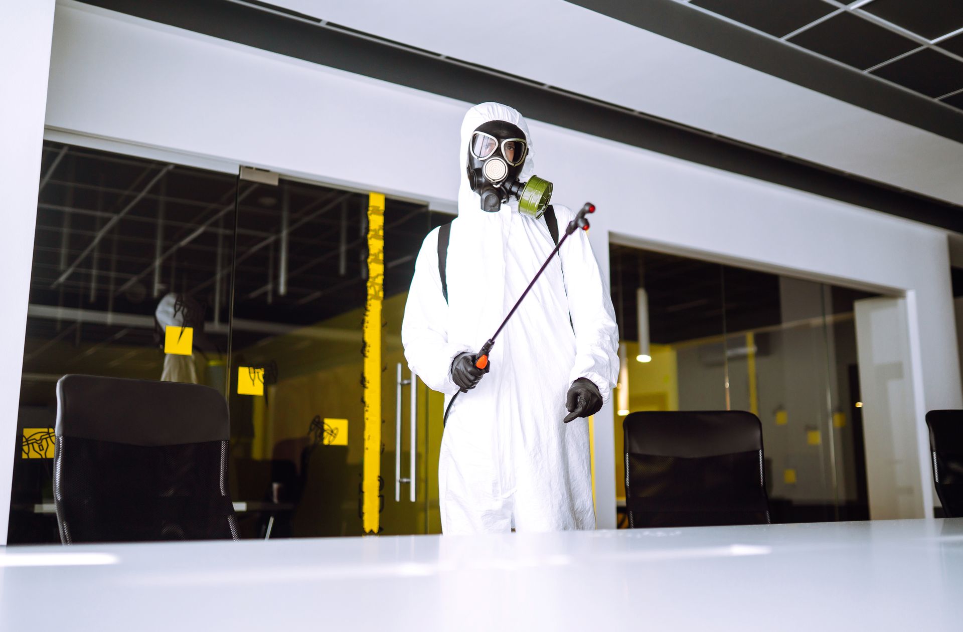 pest control worker spraying pesticides in Howard, OH