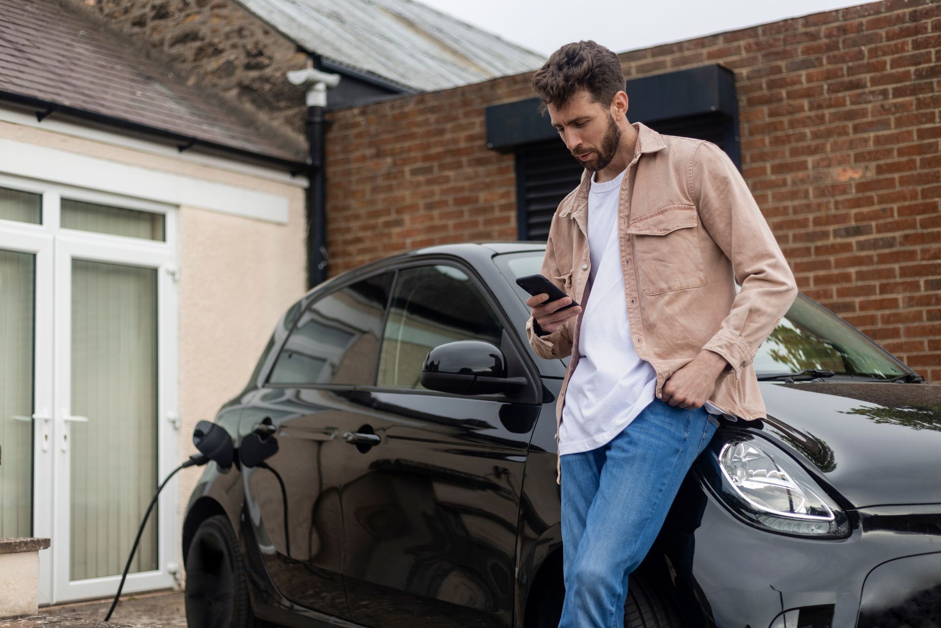 Man Checking Charging App — Runcorn, QLD — Runcorn Electrical Services Pty Ltd