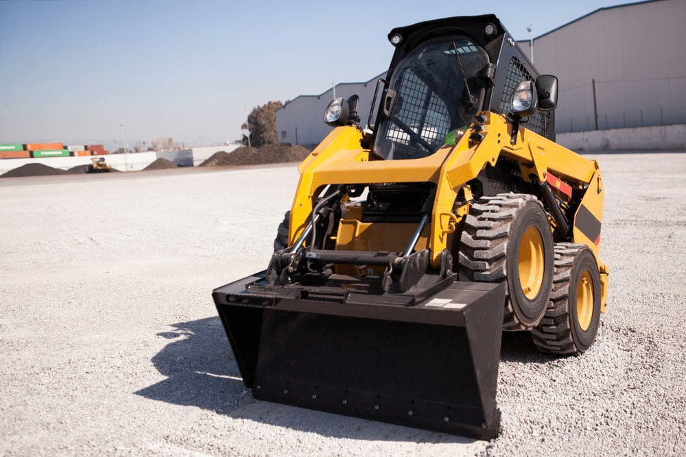 A Yellow Bulldozer Is Sitting on Top of A Dirt Field — ZBM Constructions in Wollongbar, NSW