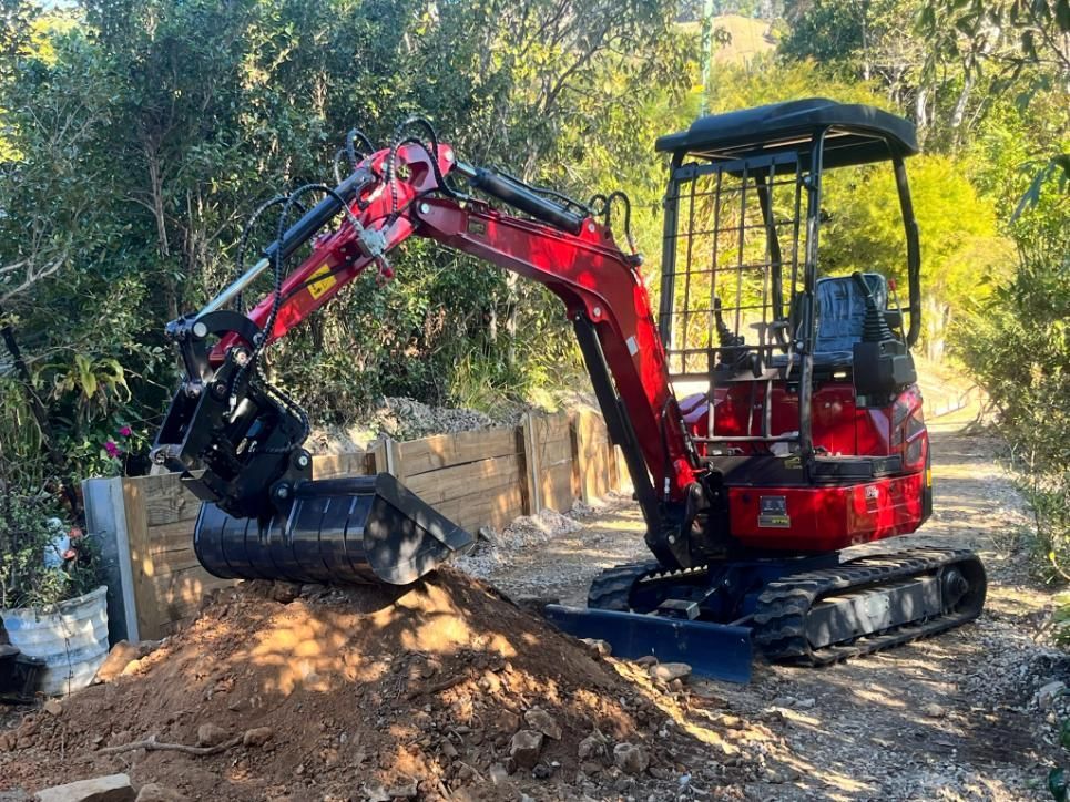 A Red Excavator Is Sitting on Top of A Pile of Dirt — ZBM Constructions in Wollongbar, NSW