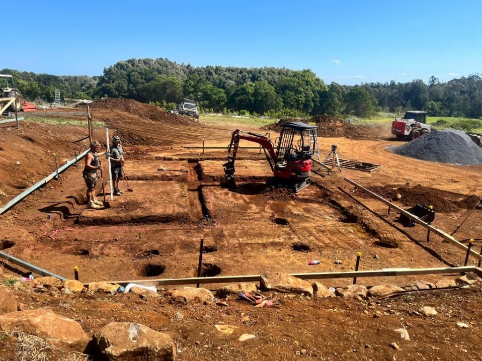 A Construction Site with A Red Excavator in The Middle of It — ZBM Constructions in Wollongbar, NSW