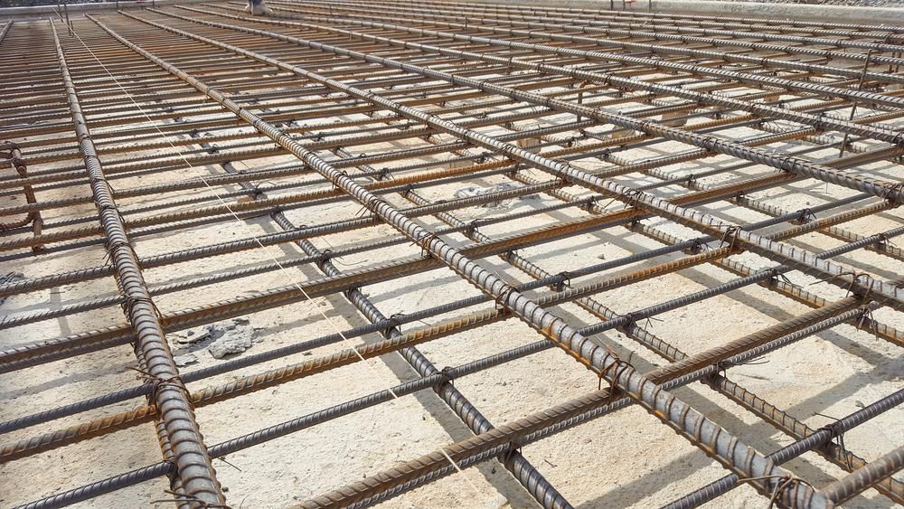 A Concrete Floor with A Lot of Steel Bars on It — ZBM Constructions in Wollongbar, NSW