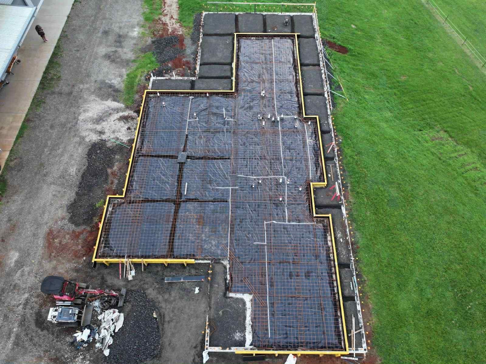 An aerial view of a building under construction in a field — ZBM Constructions in Wollongbar, NSW