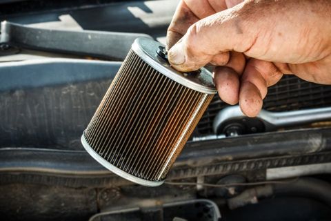 the mechanic is changing Oil and fuel filter