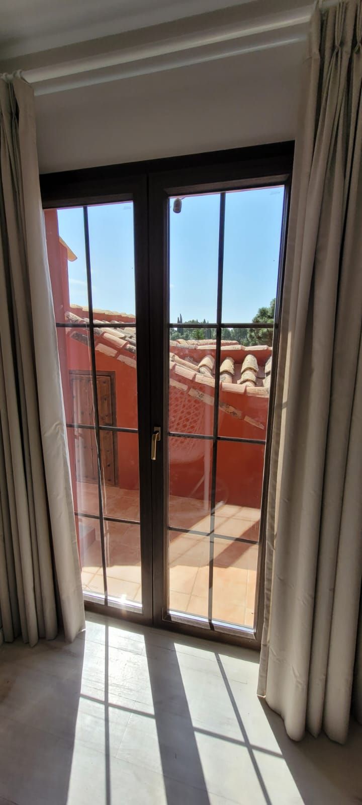 Una habitación con una puerta corrediza de vidrio que conduce a un balcón.