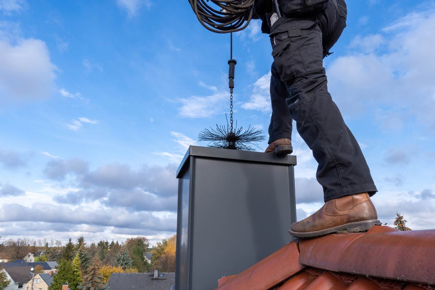 Man Cleaning A Chimney