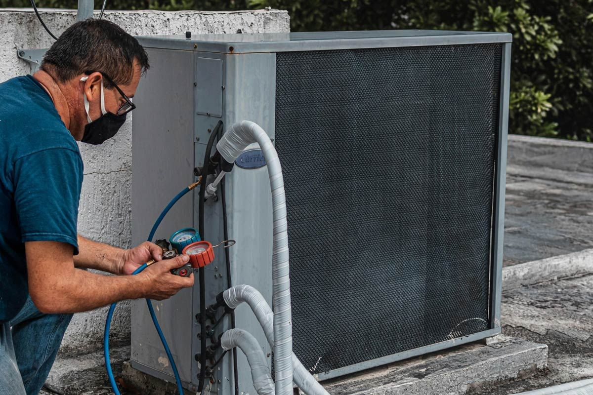 Man Inspecting An HVAC System