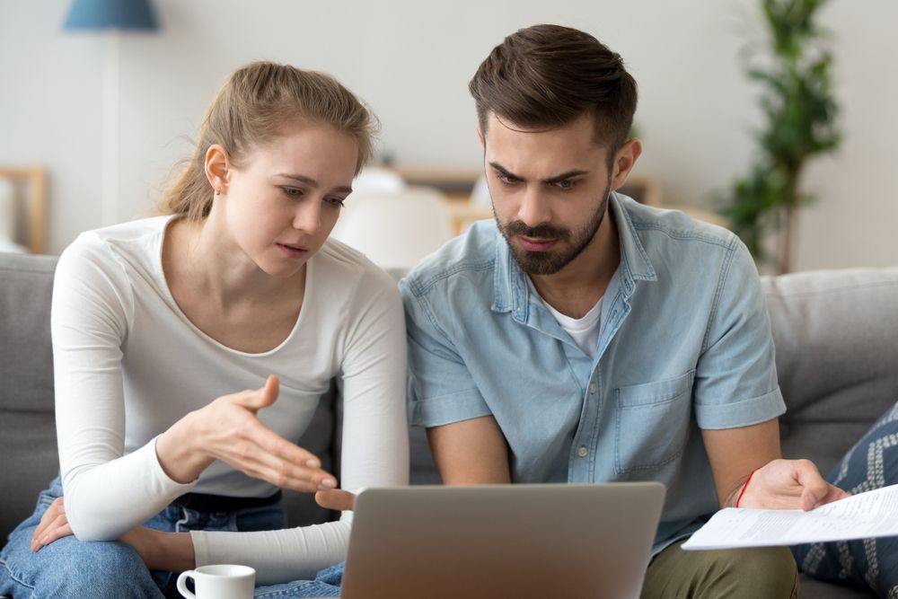 Woman Points at Laptop Screen; Man Looks Concerned — Cape York Accounting Smithfield in Smithfield, QLD