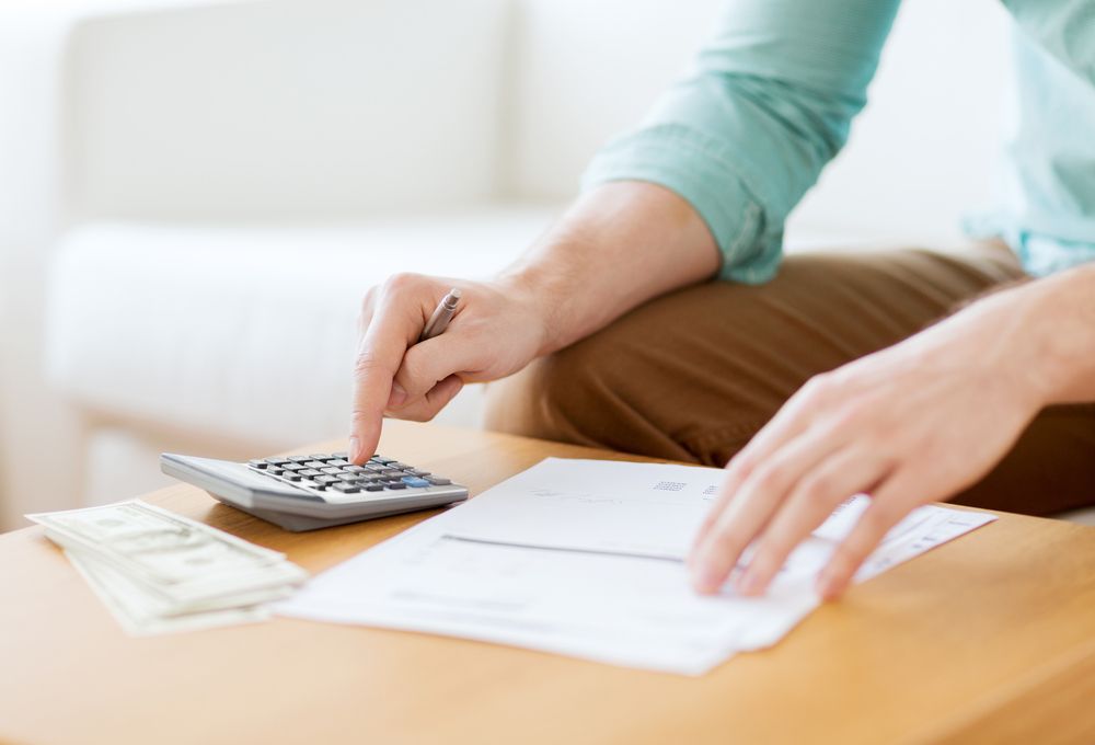 Person Calculating Finances — Cape York Accounting Smithfield in Smithfield, QLD