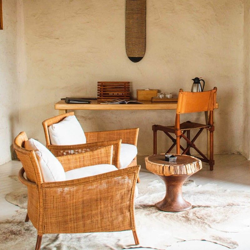 The sitting area inside Nxai Pan Camp in Botswana is featured in this inviting travel photograph, highlighting a warm and relaxed interior designed for comfort in a remote wilderness setting. Thoughtfully arranged seating, natural textures, and soft neutral tones create a welcoming space where guests can unwind between game drives. Large open sides and windows allow natural light to flood the room while offering views across the vast Nxai Pan landscape, maintaining a strong connection to the surrounding plains. Subtle décor elements inspired by local culture and the natural environment add character without overwhelming the space. The atmosphere reflects a balance of understated elegance and authentic safari style, providing a peaceful retreat in one of Botswana’s most striking desert ecosystems. Inspiration Africa specializes in bespoke, tailor-made journeys to Botswana and across Africa, crafting unforgettable safari experiences in exceptional wilderness destinations.