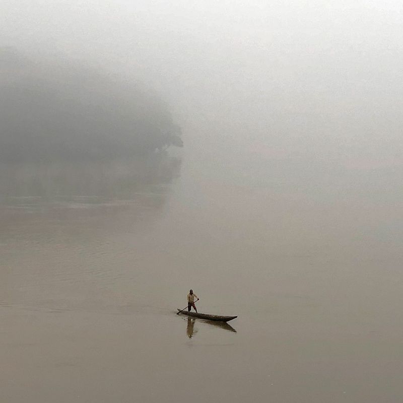 A traditional wooden boat drifts through the mist-covered waters of the Sangha River in the Central African Republic, captured in this atmospheric travel photograph. Surrounded by dense rainforest and shrouded in early morning mist, this scene highlights the region’s remote and untouched natural beauty. Traveling by boat along the Sangha River allows visitors to explore one of Central Africa’s most pristine waterways, observing wildlife, lush vegetation, and the tranquil rhythms of river life. Ideal for adventurous travelers and nature enthusiasts, this experience combines serene exploration, cultural immersion, and intimate encounters with Africa’s wild landscapes. Inspiration Africa specializes in bespoke, tailor-made journeys to the Central African Republic and across Africa, creating authentic, unforgettable travel experiences in extraordinary destinations.
