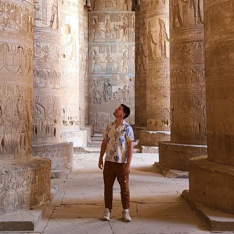 The interior of Abu Simbel Temple in Egypt is captured in this striking travel photograph, showcasing the grandeur and intricate craftsmanship of one of the ancient world’s most iconic monuments. Massive carved columns and detailed wall reliefs line the temple halls, depicting scenes of pharaohs, gods, and ceremonial life illuminated by soft ambient light. The rich textures of the stone and the scale of the architecture create a powerful sense of history, reverence, and timelessness. The scene reflects the extraordinary cultural heritage of ancient Egypt and the enduring significance of Abu Simbel as a UNESCO World Heritage Site. Inspiration Africa curates bespoke, tailor-made journeys to Egypt and across Africa, combining immersive cultural exploration with unforgettable historical and scenic experiences.