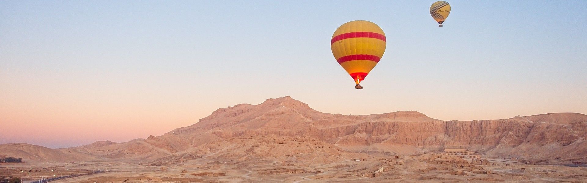 Gaze upon a breathtaking balloon flight over Luxor, Egypt, captured in this striking aerial photograph. Hot air balloons drift silently above the Nile Valley at sunrise, revealing a timeless landscape of ancient temples, fertile fields, and desert plains bathed in golden light. From above, iconic sites such as the Valley of the Kings and the riverbanks of the Nile come into view, showcasing Luxor’s extraordinary historical significance. Experiencing Luxor by balloon offers a serene and unforgettable perspective on one of the world’s greatest archaeological destinations. Inspiration Africa specializes in designing bespoke, tailor-made journeys that combine iconic cultural experiences with extraordinary travel moments.