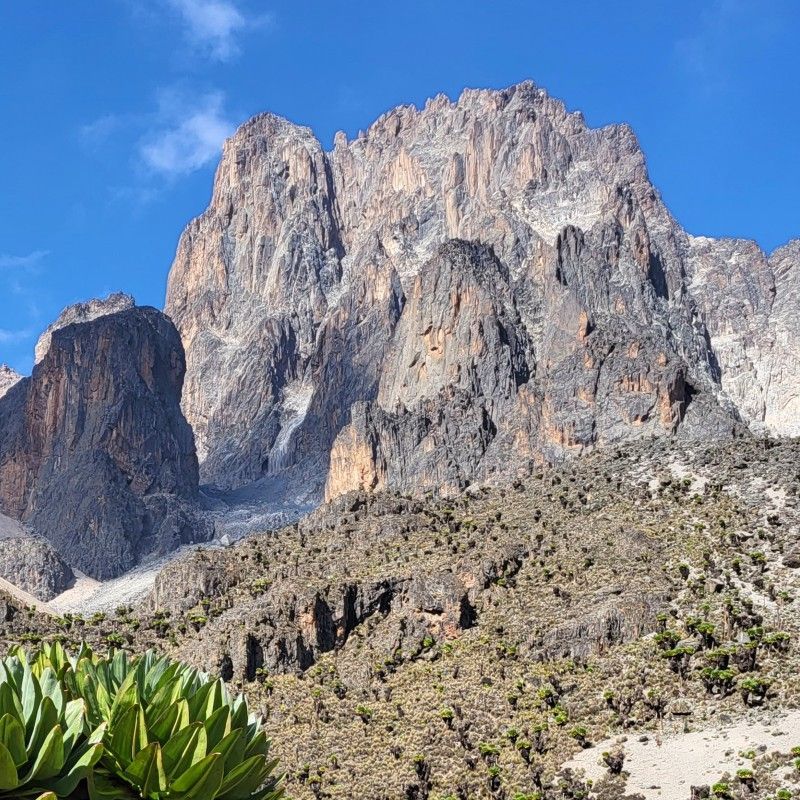 Mount Kenya rises dramatically above the surrounding landscapes, captured in this striking travel photograph showcasing one of East Africa’s most iconic natural landmarks. As Africa’s second-highest mountain and a UNESCO World Heritage Site, Mount Kenya is renowned for its jagged peaks, alpine scenery, and diverse ecosystems ranging from dense forests to high-altitude moorlands. Trekking and exploring Mount Kenya offers adventurous travelers breathtaking views, unique flora, and an authentic wilderness experience away from the crowds. Ideal for hikers, nature lovers, and photographers, this destination highlights Kenya’s rich natural heritage and scenic beauty. Inspiration Africa specializes in bespoke, tailor-made journeys to Kenya and across Africa, crafting unforgettable trekking adventures and immersive nature experiences in extraordinary destinations.