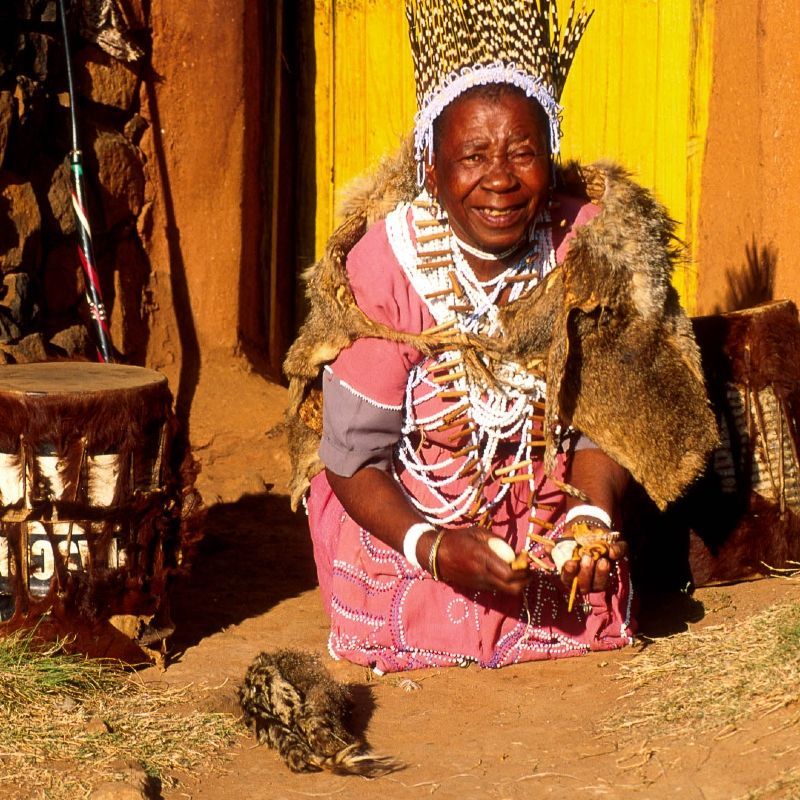 A village healer in Lesotho, adorned with a traditional headdress, performs rituals rooted in ancestral knowledge and spiritual customs that remain central to Basotho culture. These sacred practices offer deep insight into Lesotho’s living heritage and community life. Visitors can witness or learn about these traditions in rural villages, where oral histories and healing methods are passed down through generations. Inspiration Africa organizes culturally respectful travel to Lesotho, offering opportunities to engage with local traditions and communities in meaningful ways. Experience the spiritual richness and cultural depth of Lesotho with thoughtfully curated journeys led by Inspiration Africa.