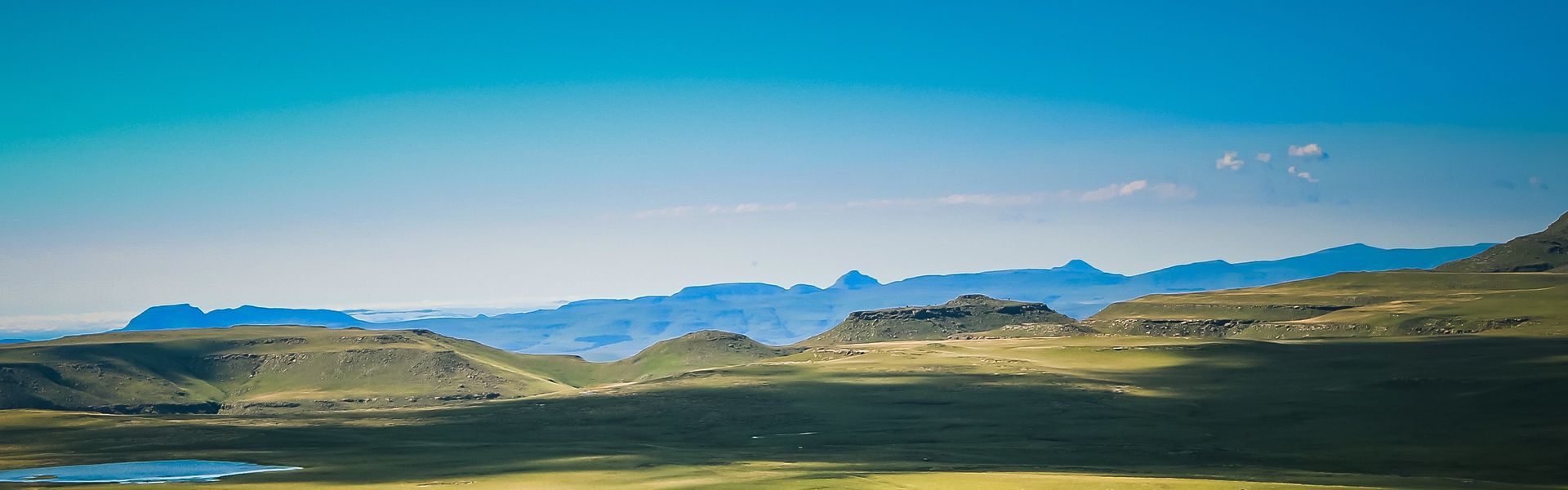 Experience the breathtaking scenery of Lesotho’s highlands with panoramic views toward Jonathan’s Gate and Bushman’s Nek Pass in the Southern Drakensberg, where rugged landscapes, winding mountain passes, and rich cultural heritage come together in a remote setting.