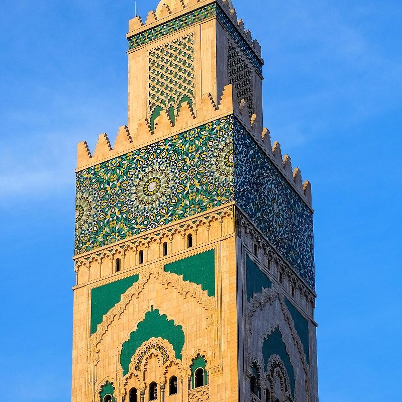 Experience the architectural and cultural beauty of Morocco with this striking image of the minaret of Casablanca’s most important mosque. The photo captures the towering structure against a clear sky, highlighting intricate geometric patterns, ornate details, and the craftsmanship that defines Moroccan Islamic architecture. The scene reflects both the spiritual significance and the historic grandeur of the mosque, offering a glimpse into the vibrant cultural heritage of Casablanca.
Inspiration Africa designs tailor-made journeys to Morocco, giving travellers the opportunity to explore iconic landmarks, admire stunning architecture, and immerse themselves in the rich history and traditions of this dynamic North African city.