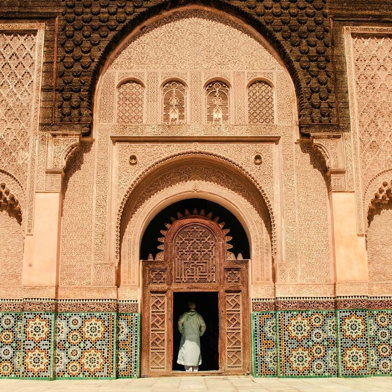 Gaze upon the intricate beauty of a Moroccan building adorned with elaborate tiles and ornate architectural details. This striking photograph captures the vibrant geometric patterns, colorful mosaics, and finely crafted craftsmanship that exemplify Morocco’s rich artistic heritage. Sunlight highlights the textures and precision of the designs, reflecting centuries of Islamic and local architectural influence. Experiencing such exquisite structures offers an immersive journey into Morocco’s culture, history, and timeless artistry. Inspiration Africa specializes in designing bespoke, tailor-made journeys that combine cultural exploration with extraordinary experiences across Africa’s most remarkable destinations.