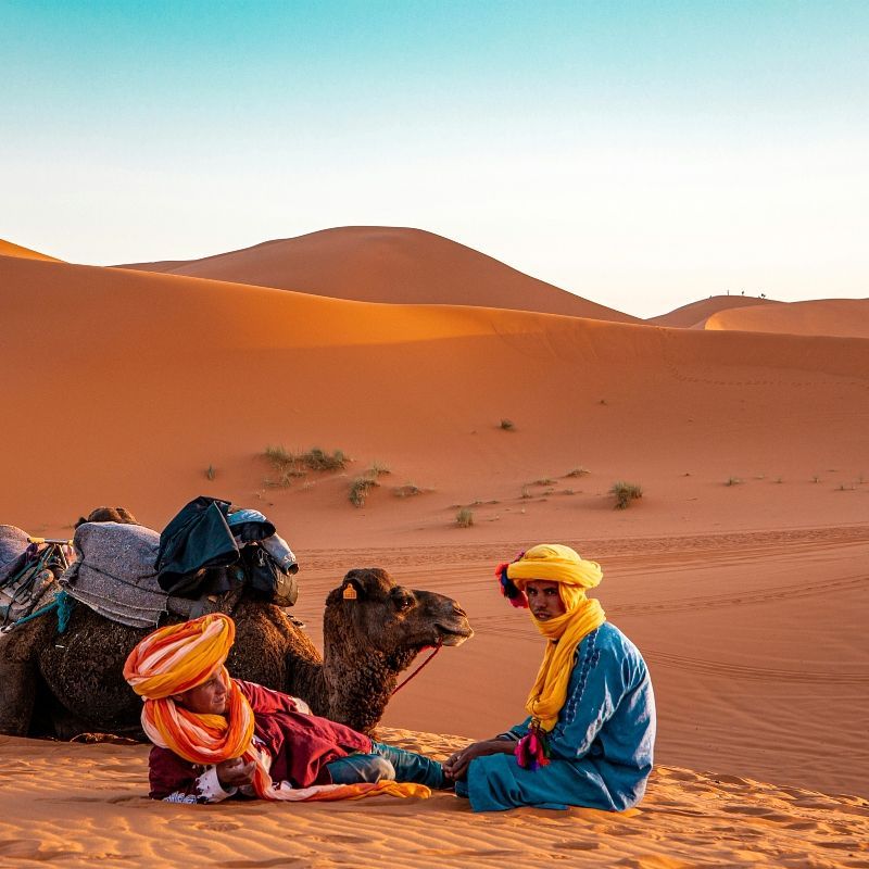 Experience the timeless spirit of the Sahara with this evocative image of a Tuareg man and his camel in Merzouga, Morocco. Set against towering dunes and golden desert light, the photo captures the deep connection between the Tuareg people and the desert landscapes they have navigated for centuries. The man’s traditional indigo attire and the calm presence of his camel highlight the enduring cultural heritage and nomadic traditions of Morocco’s desert communities.
Inspiration Africa designs tailor-made journeys to Morocco, offering immersive experiences in Merzouga and beyond. Explore the sweeping dunes, meet local desert guides and discover the rich culture and natural beauty of the Moroccan Sahara.