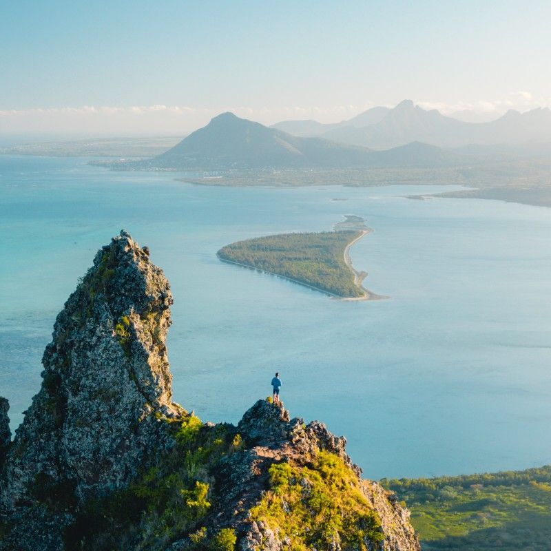 Hikers make their way along the trails of Le Morne Brabant in Mauritius, captured in this breathtaking adventure travel photograph. Rising dramatically above the turquoise waters of the Indian Ocean, Le Morne offers panoramic views of lush greenery, coral reefs, and pristine beaches, making it one of Mauritius’s most iconic landmarks. Trekking here combines physical challenge with stunning scenery, allowing travelers to explore tropical forests, rugged cliffs, and panoramic coastal vistas. Ideal for adventure seekers, nature enthusiasts, and photographers, this hike showcases the island’s unique blend of natural beauty and cultural heritage. Inspiration Africa specializes in bespoke, tailor-made journeys to Mauritius and across Africa, crafting authentic, unforgettable hiking and adventure experiences in extraordinary destinations.