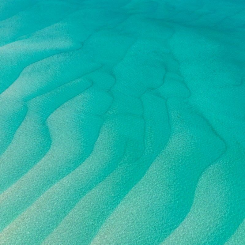 Gaze upon the breathtaking aerial view of the Bazaruto Archipelago in Mozambique, where pristine sandbanks meet crystal-clear turquoise waters. This stunning photograph captures the dramatic contrast between soft white sands, vibrant coral reefs, and the sparkling Indian Ocean, highlighting one of Africa’s most beautiful and remote coastal paradises. The archipelago is renowned for its marine biodiversity, tranquil beaches, and idyllic island escapes. Experiencing Bazaruto offers an unforgettable journey into Mozambique’s natural beauty and coastal treasures. Inspiration Africa specializes in crafting bespoke, tailor-made journeys that showcase Africa’s most extraordinary islands, seascapes, and immersive travel experiences.