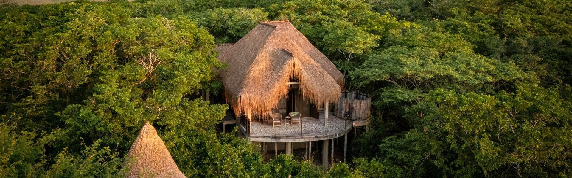 One of the villas at House Marapé in Mozambique is captured in this striking aerial travel photograph, showcasing the property set along the pristine coastline of the Indian Ocean. Surrounded by lush tropical vegetation and golden sandy beaches, the villa’s design blends seamlessly with its natural environment, offering privacy and panoramic ocean views. The turquoise waters and gentle waves of the sea create a dramatic backdrop, while open decks and thatched roofs emphasize indoor-outdoor living and connection to the landscape. The scene conveys exclusivity, tranquility, and the appeal of a luxurious coastal retreat, highlighting House Marapé as an idyllic destination for relaxation and immersion in Mozambique’s scenic coastline. Inspiration Africa specializes in bespoke, tailor-made journeys to Mozambique and across Africa, crafting unforgettable travel experiences in extraordinary destinations.