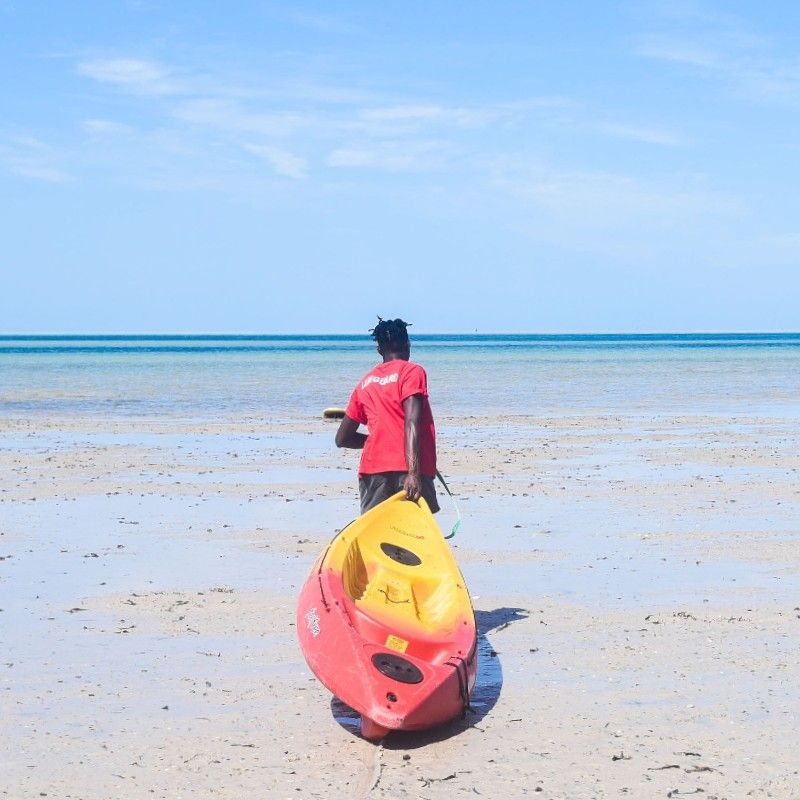 A local guide pulls a sea kayak across soft white sand toward the turquoise waters of the Indian Ocean in Vilanculos, Mozambique, captured in this inspiring coastal adventure photograph. Set along Mozambique’s pristine coastline, Vilanculos is the gateway to the Bazaruto Archipelago, renowned for its crystal-clear waters, coral reefs, and exceptional marine life. Sea kayaking here offers an active yet tranquil way to explore unspoiled beaches, tropical seascapes, and remote islands. Ideal for adventure travelers and ocean lovers, this experience highlights the diversity of African travel beyond safari. Inspiration Africa creates bespoke, tailor-made journeys to Mozambique and across Africa, combining authentic experiences, outdoor activities, and exclusive destinations for unforgettable trips.