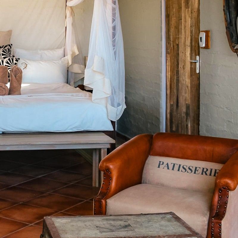 The beautifully designed rooms at Wolwedans Dune Camp in Namibia are showcased in this evocative travel photograph, offering an intimate blend of comfort, simplicity, and desert elegance. Elevated above the dunes, the rooms feature natural materials, handcrafted furnishings, and soft, earthy tones that mirror the surrounding NamibRand landscape. Open layouts and wide windows create a strong sense of space and connection to the vast desert beyond, allowing light, air, and sweeping views to define the experience. The rooms reflect Wolwedans’ commitment to sustainability, authenticity, and understated luxury, providing a peaceful retreat immersed in one of the world’s most striking desert environments. Ideal for travelers seeking seclusion, design-led accommodation, and a deep connection to nature, this scene captures the tranquility and timeless beauty of Wolwedans Dune Camp. Inspiration Africa specializes in bespoke, tailor-made journeys to Namibia and across Africa, crafting unforgettable desert stays and immersive wilderness experiences.